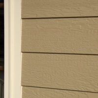 Brown Smartside Siding boards on side of house.
